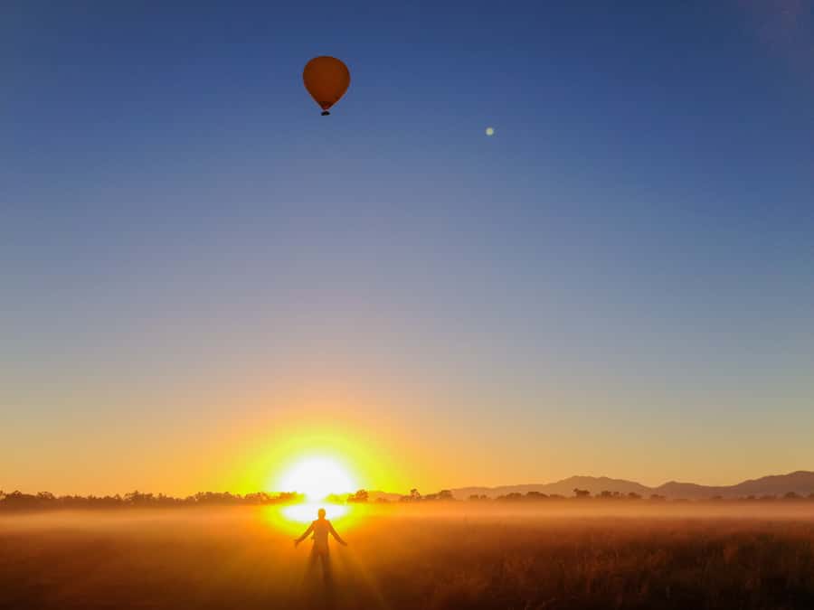 Cairns: Hot Air Balloon Flight with Transfers - Watching a balloon grow taller than a building