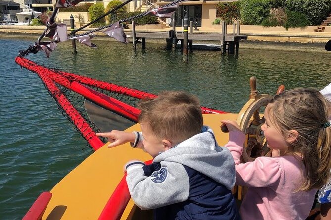 The Pirate Cruise in Mandurah on Viator - Steering the wheel, ringing the bell, and playing pirate